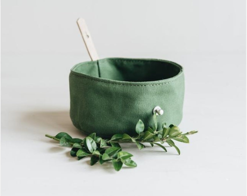 Green fabric travel bowl for dogs and cats