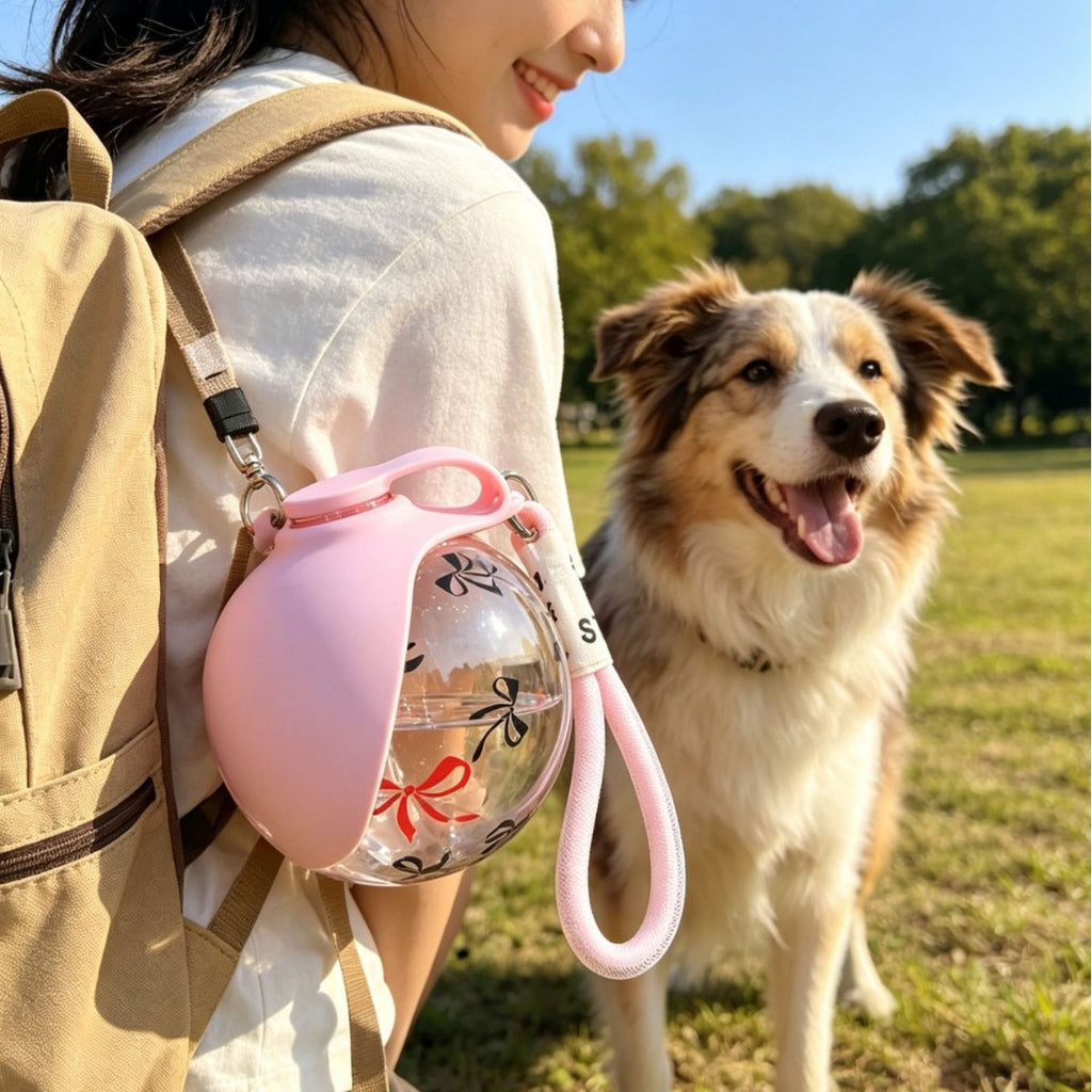 Travel dog water bottle hooked to backpack
